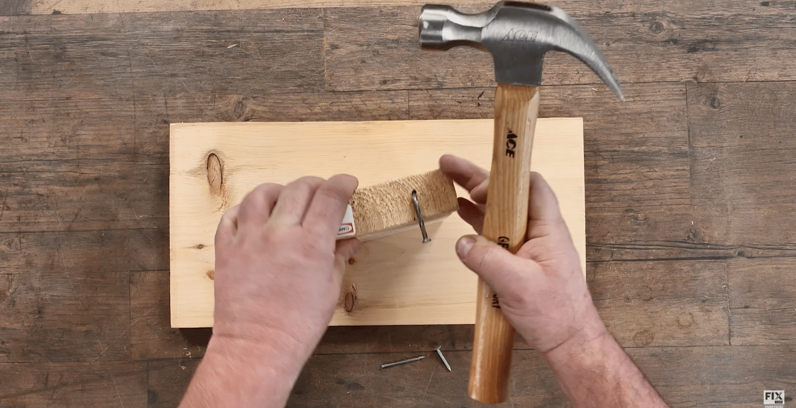 Bending a Nail using a Hammer into a Wooden Block