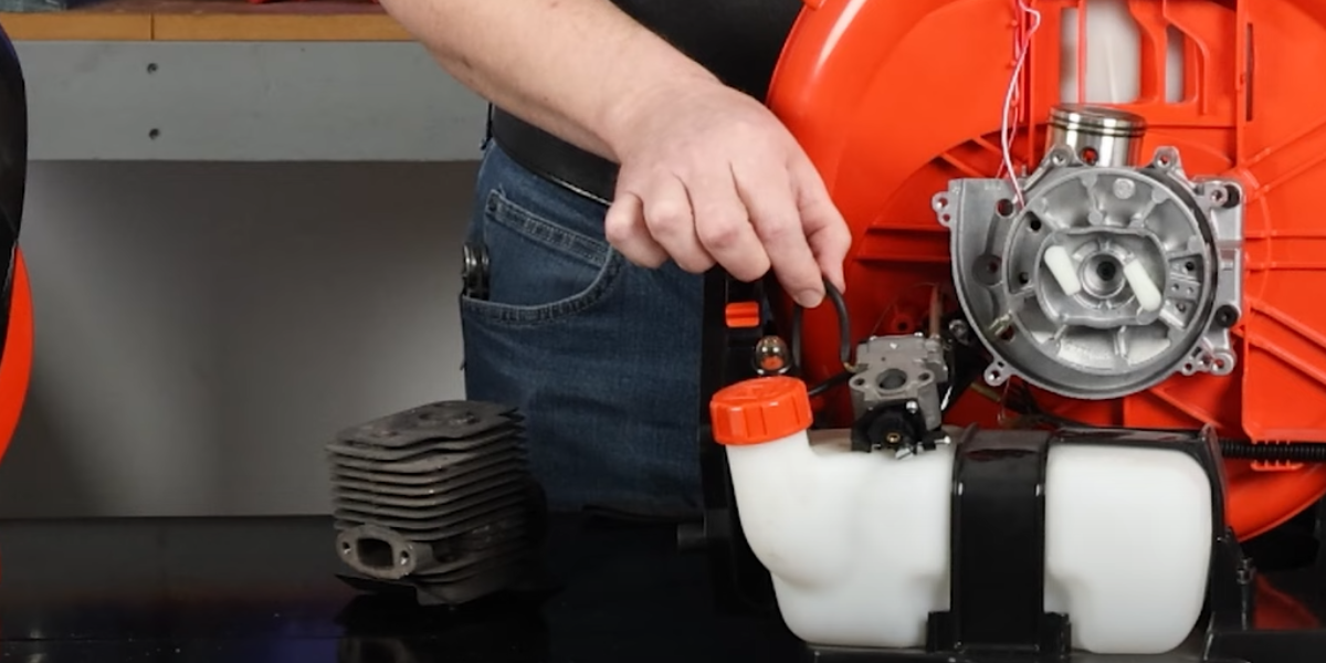 The fuel lines are visible and connected to the fuel tank and carburetor, which shows the flow of fuel through the leaf blower.
