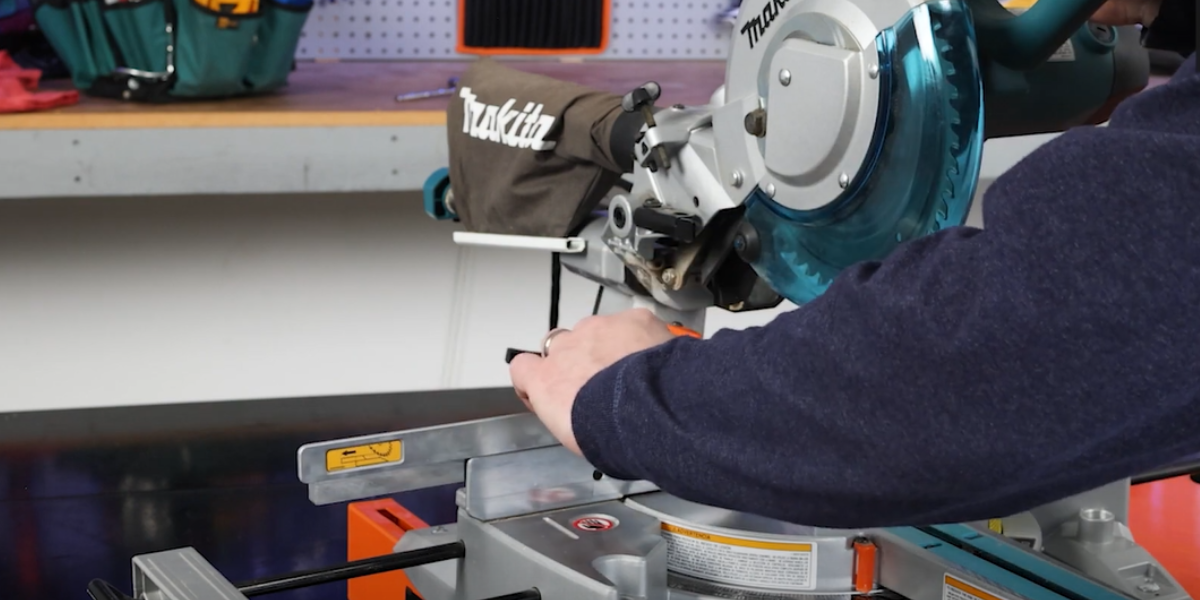 Upper portion of saw fence sliding to the side to create room for bevel adjustment