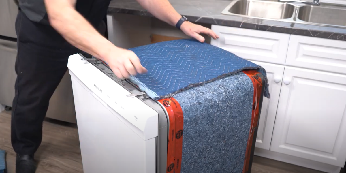 How to Soundproof Your Dishwasher: Use a shipping blanket to add more soundproofing to your dishwasher