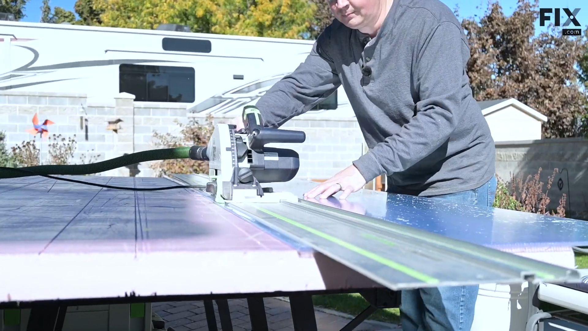 Expert technician cutting a sheet of double-wall polycarbonate with a track saw