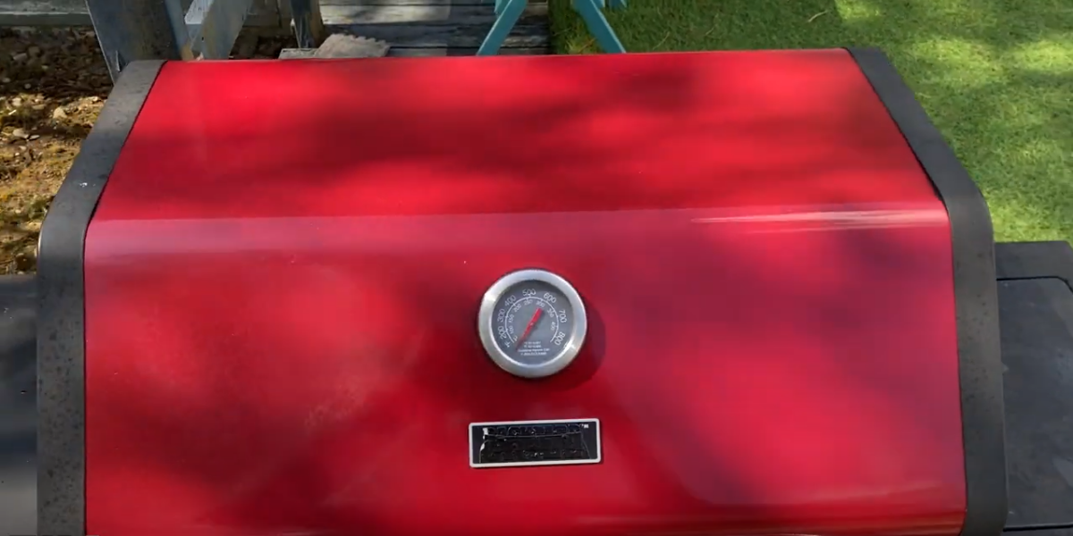 The red exterior of a used grill is free of rust and corrosion