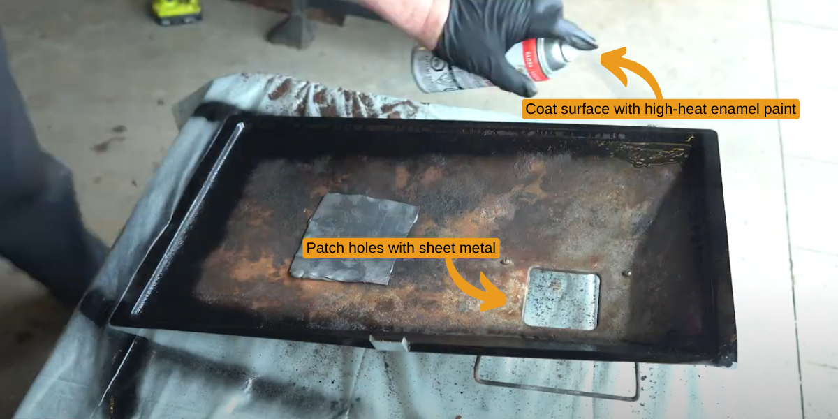 The drip tray in a used grilled being repaired with sheet metal and spray paint