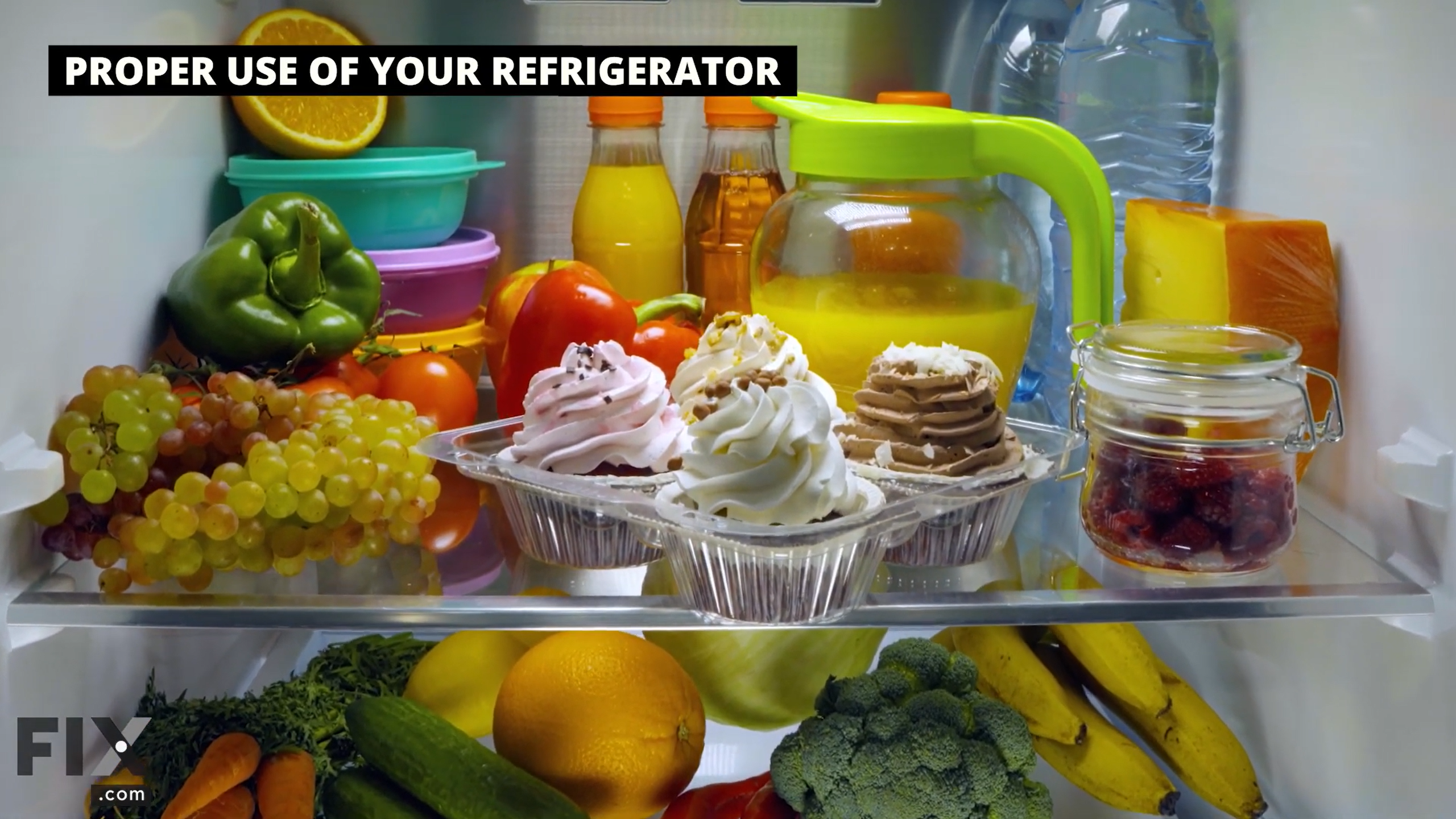 Fridge shelf filled with cupcakes, fruits, vegetables, and drinks.