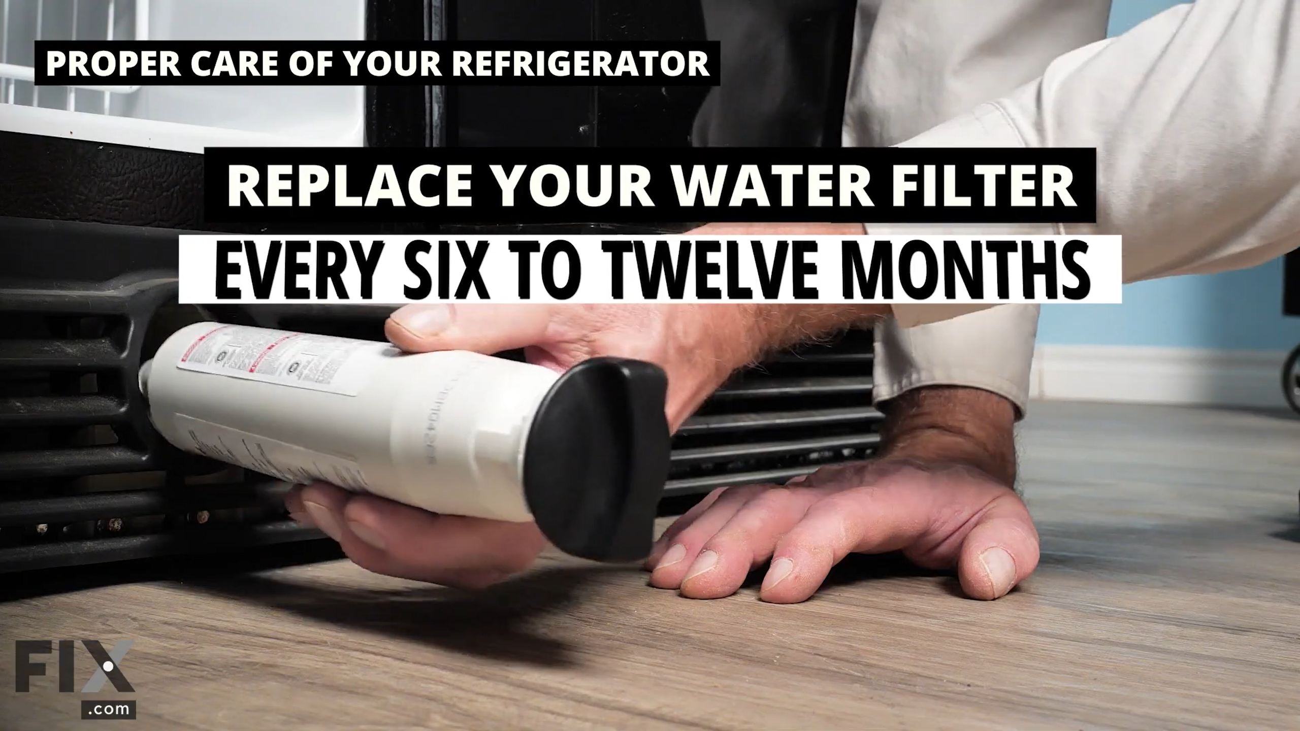 Water filter being removed from bottom of refrigerator.