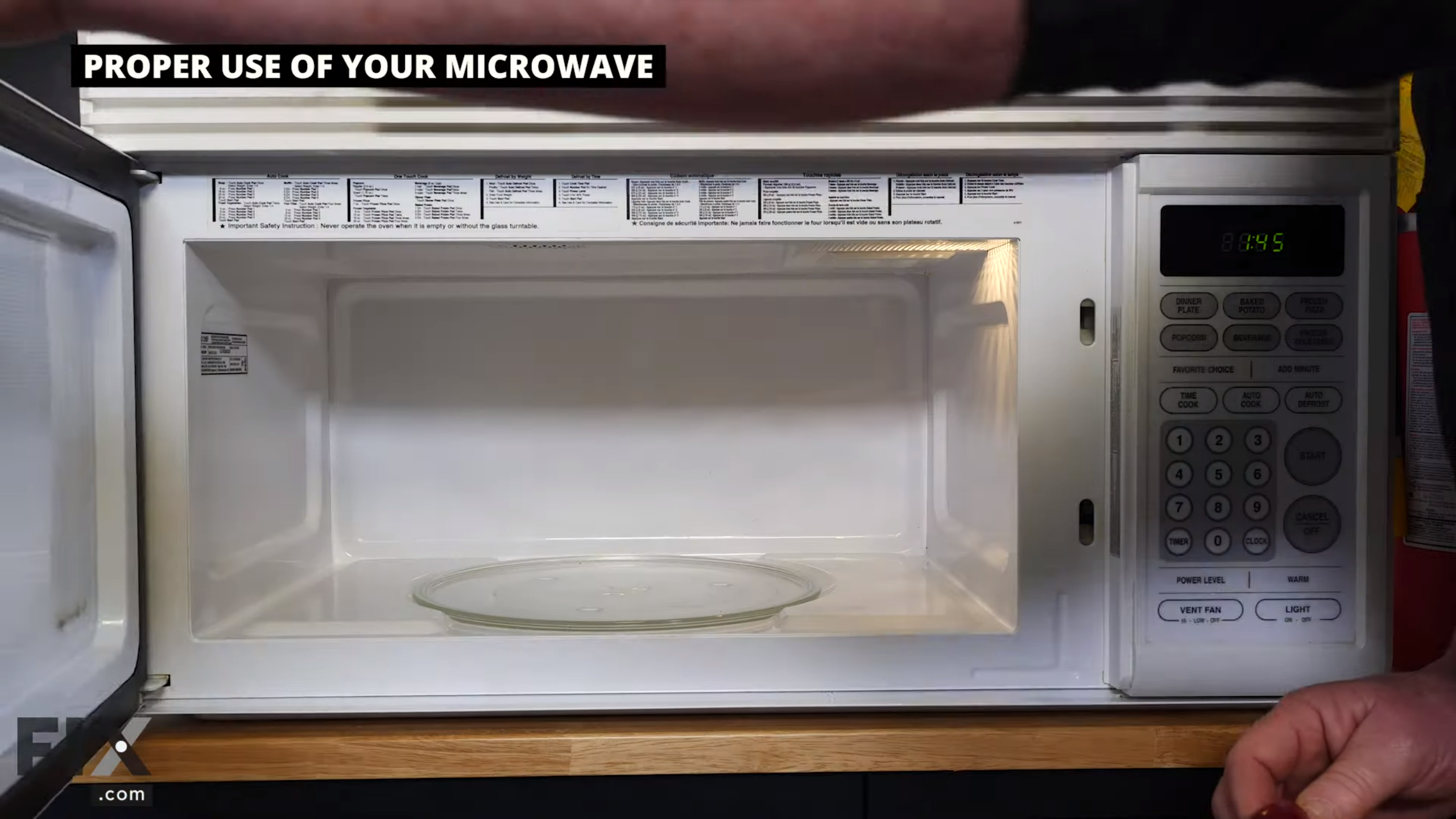 Open microwave with a clear glass tray inside.